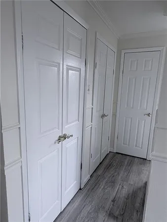 a view of a closet area with wooden floor