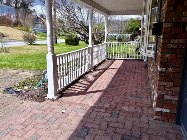 a view of a pathway with a garden