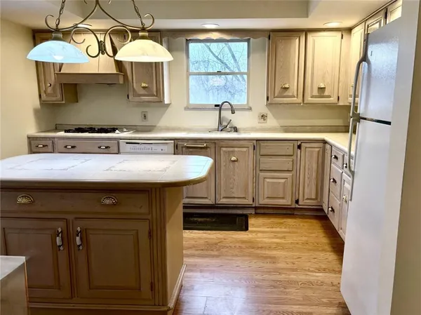 a kitchen with a sink cabinets and appliances