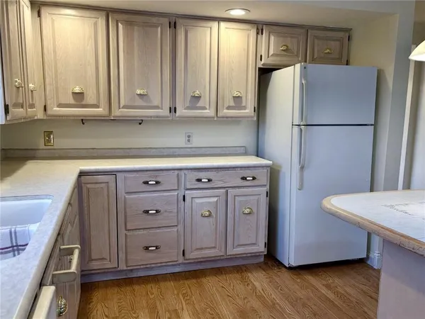 a kitchen with stainless steel appliances a refrigerator and cabinets
