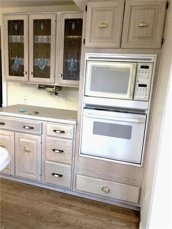 a kitchen with granite countertop white cabinets and a stove