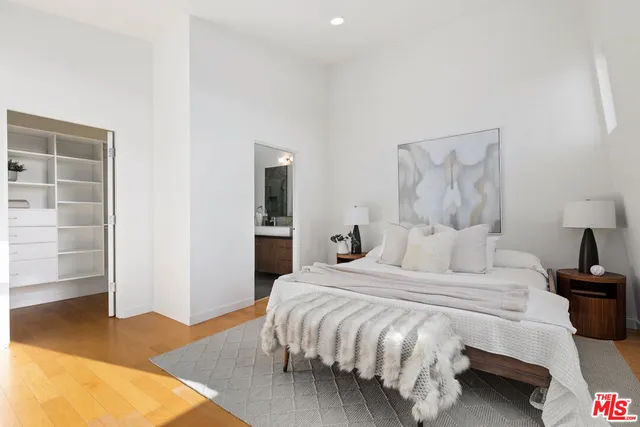 a bedroom with a bed and a lamp