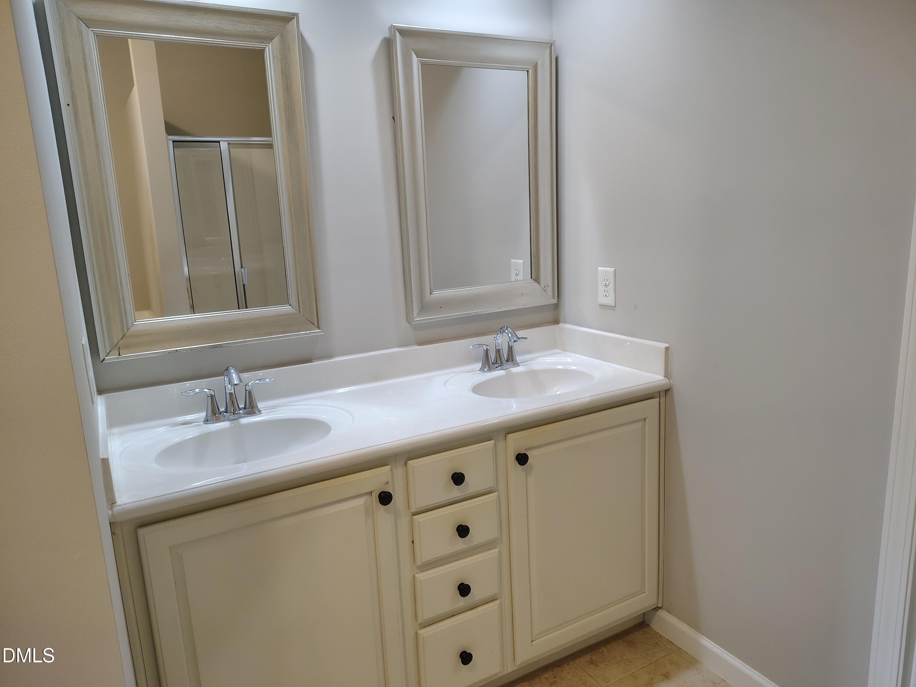 831 Davidson Point Road Cary, NC 27513 - Photo 13 of 22 a bathroom with 2 sink and a mirror