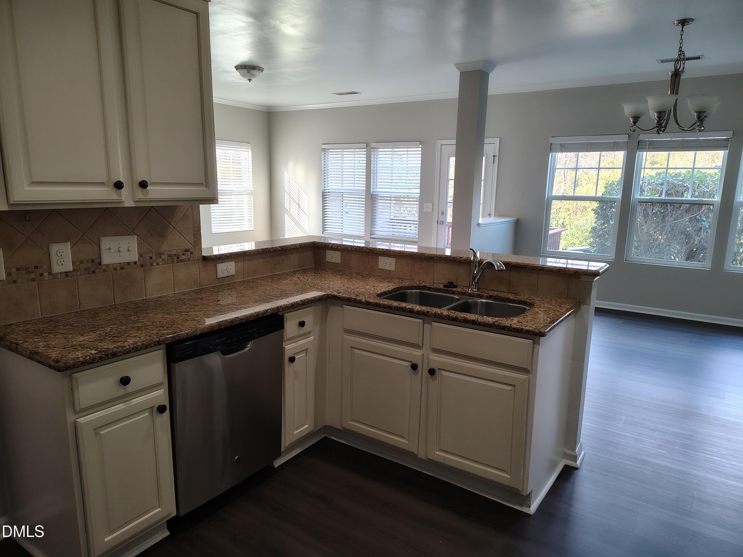 831 Davidson Point Road Cary, NC 27513 - Photo 5 of 22 a kitchen with granite countertop a sink a stove and cabinets
