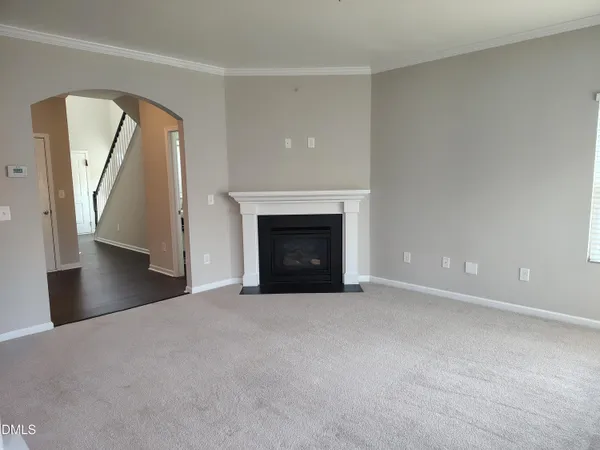 a view of an empty room with a fireplace