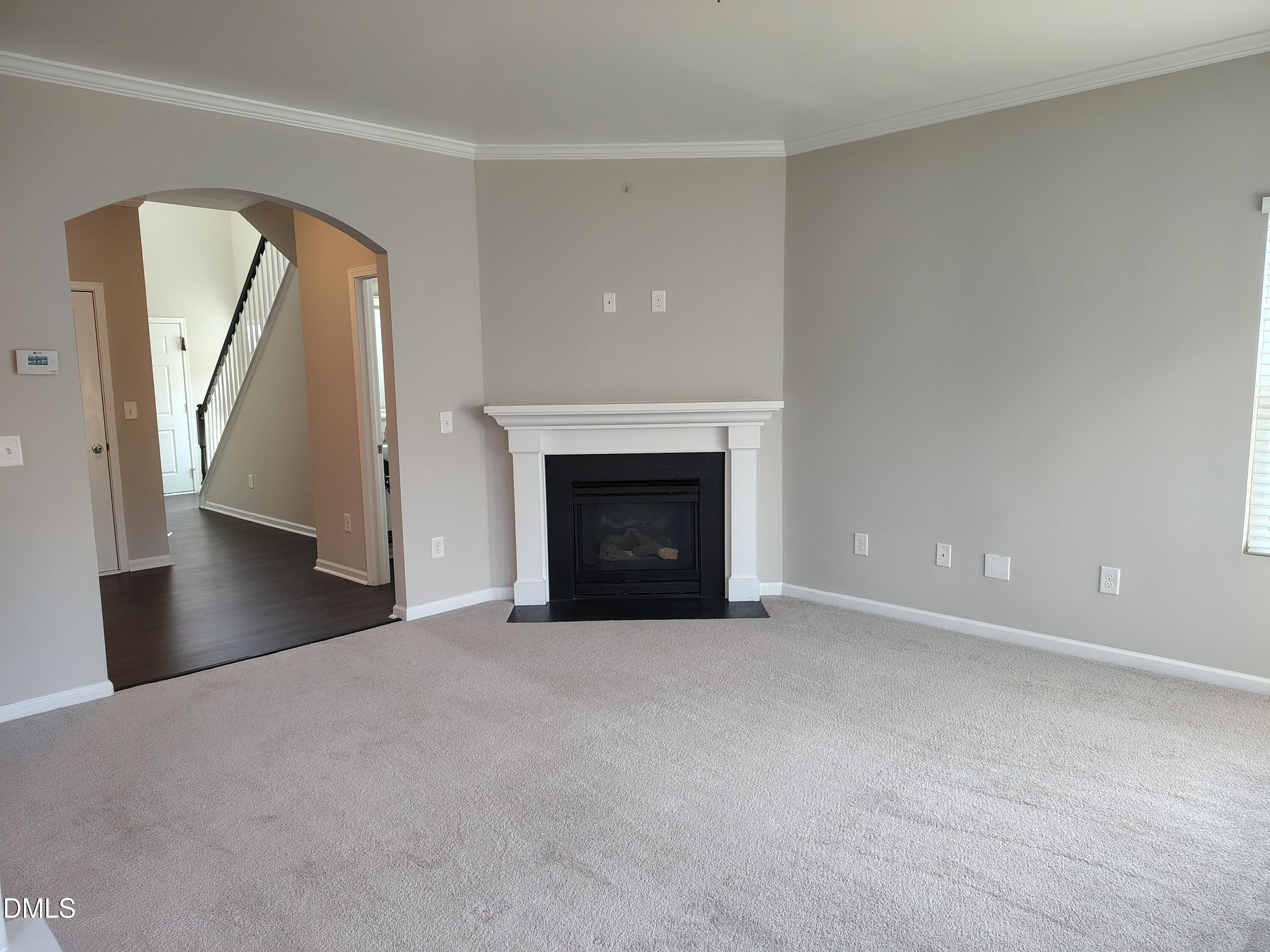831 Davidson Point Road Cary, NC 27513 - Photo 7 of 22 a view of an empty room with a fireplace
