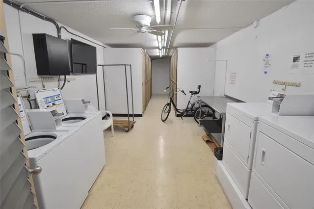 a view of a room with gym equipment and a flat screen tv