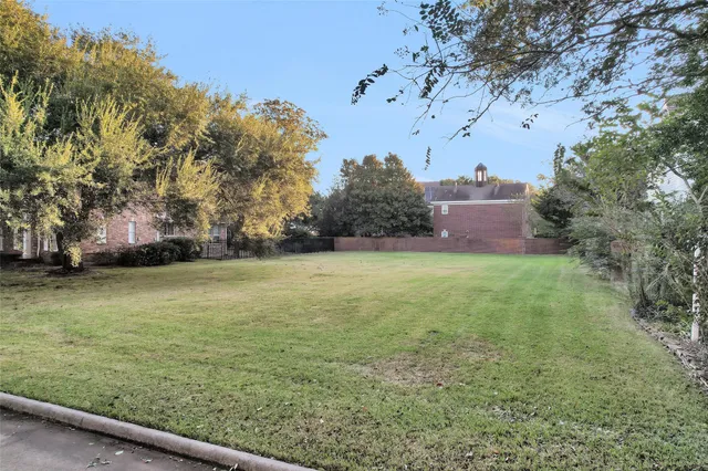 a view of a field of grass and trees