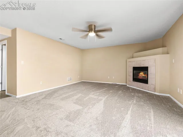 a view of empty room with fireplace