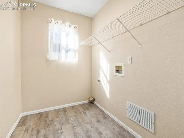 a view of small space with wooden floor and windows