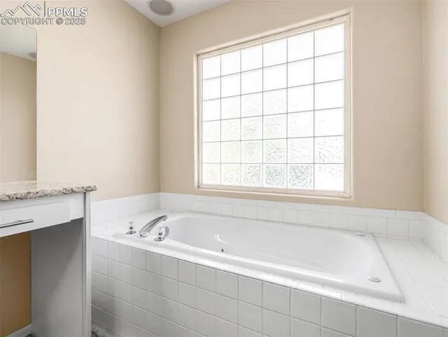 a white bath tub sitting next to a window