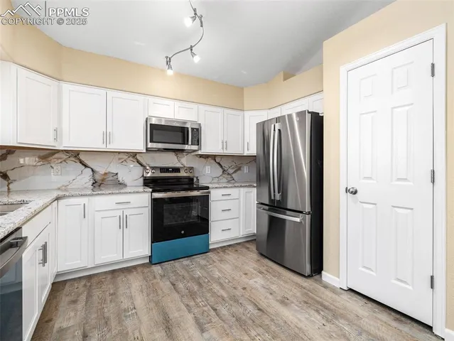 a kitchen with a refrigerator stove and sink