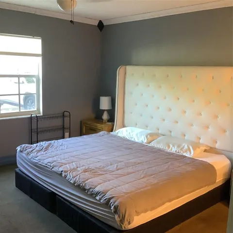 a bedroom with a bed and window