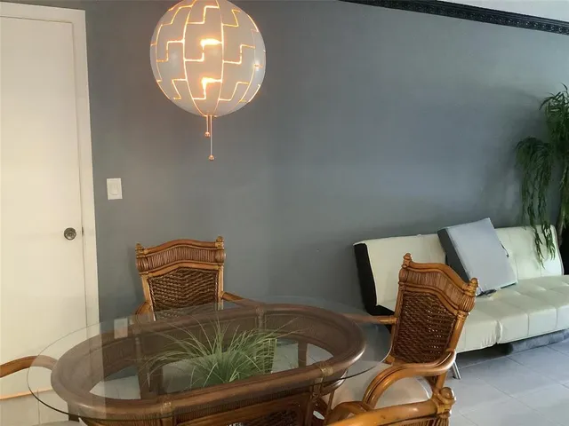 a living room with furniture and a mirror