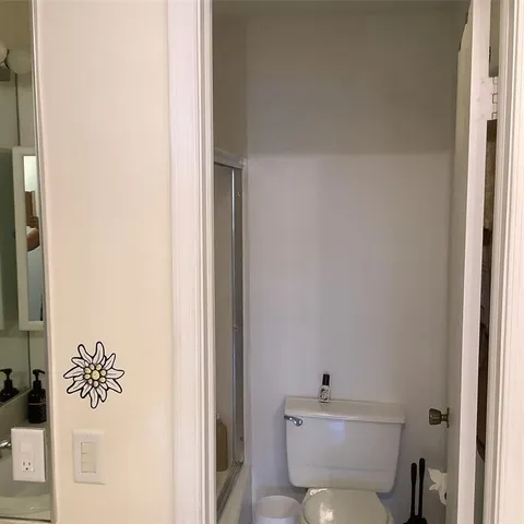 a white toilet sitting next to a bathroom sink