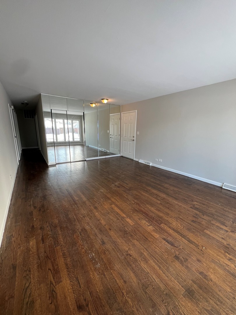 1171 South Ridge Avenue Arlington Heights, IL 60005 - Photo 3 of 12 an empty room with wooden floor and windows