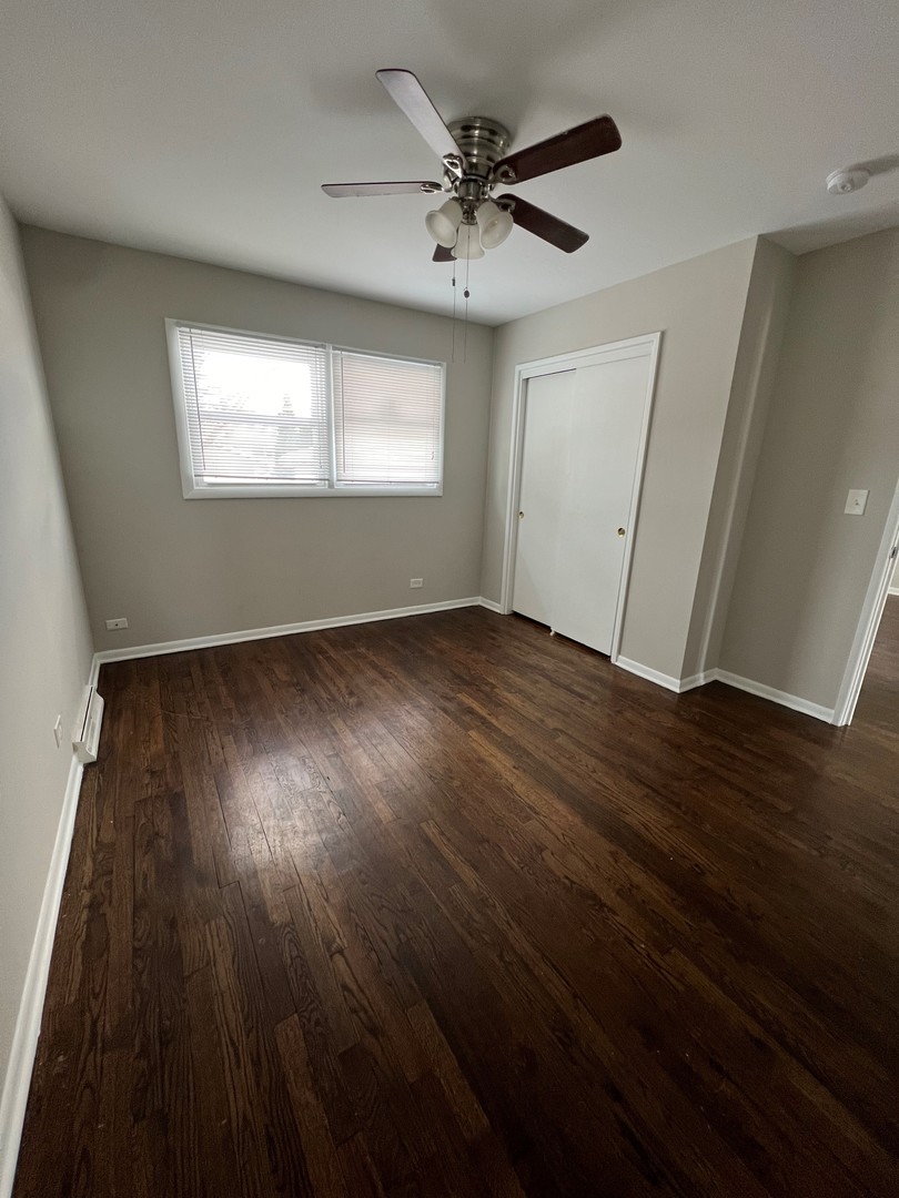 1171 South Ridge Avenue Arlington Heights, IL 60005 - Photo 7 of 12 a view of an empty room with wooden floor and a window
