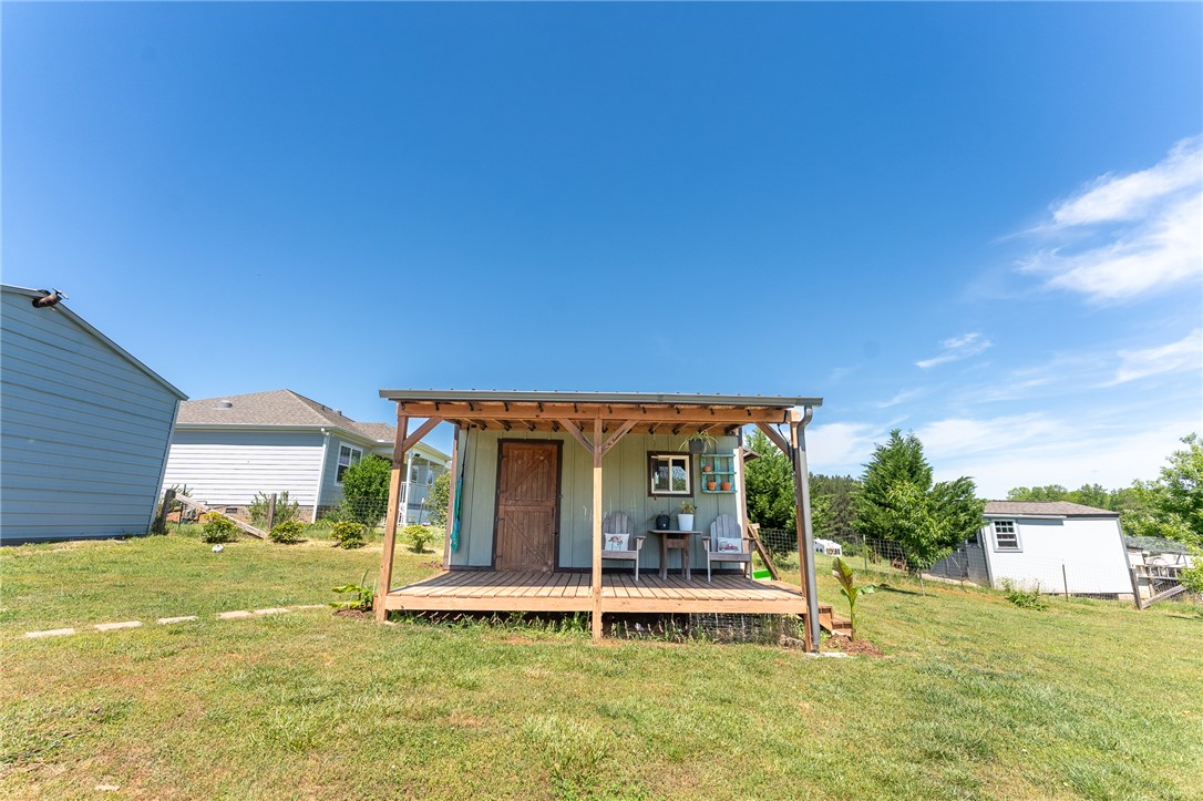 696 Mt Olivet Road Six Mile, SC 29682 - Photo 25 of 35 This outdoor shed features a charming covered porch, perfect for enjoying the serene yard.