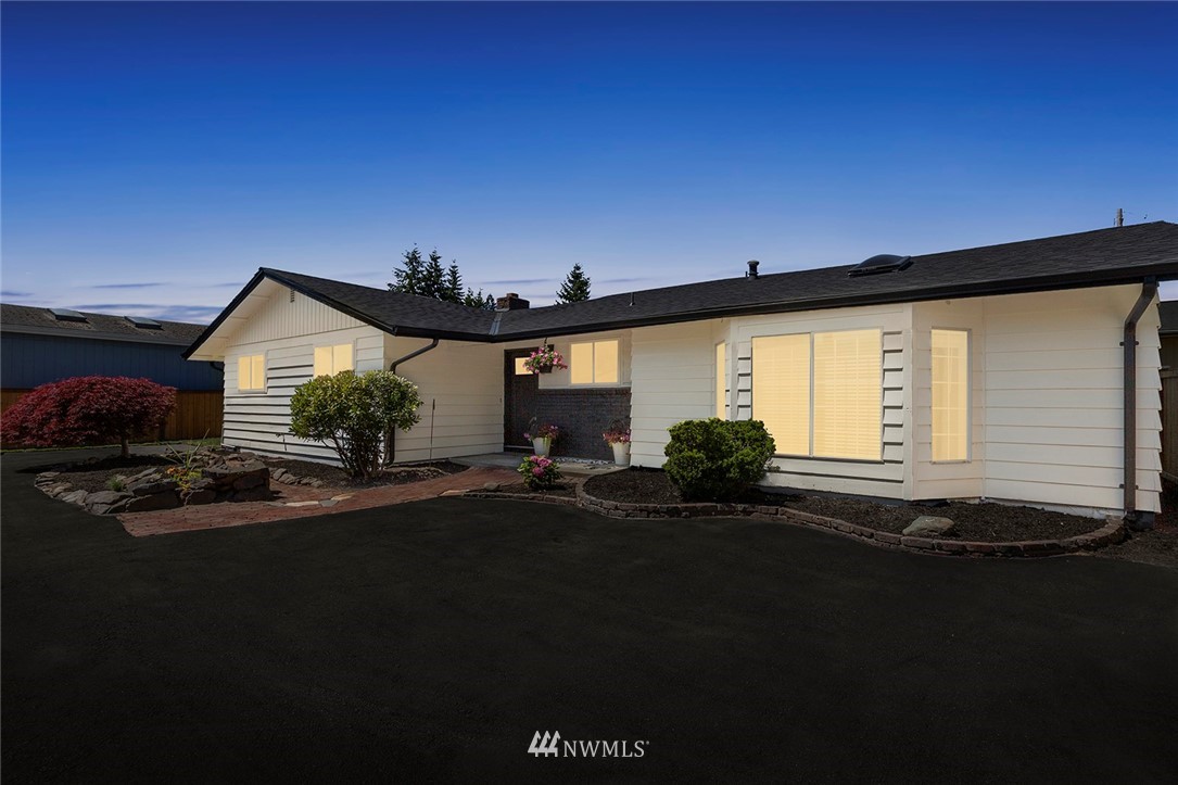 2212 Edmonds Avenue Northeast Renton, WA 98056 - Photo 2 of 18 a front view of a house with a yard