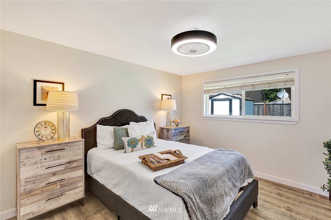2212 Edmonds Avenue Northeast Renton, WA 98056 - Photo 12 of 18 a bedroom with a bed and painting on the wall