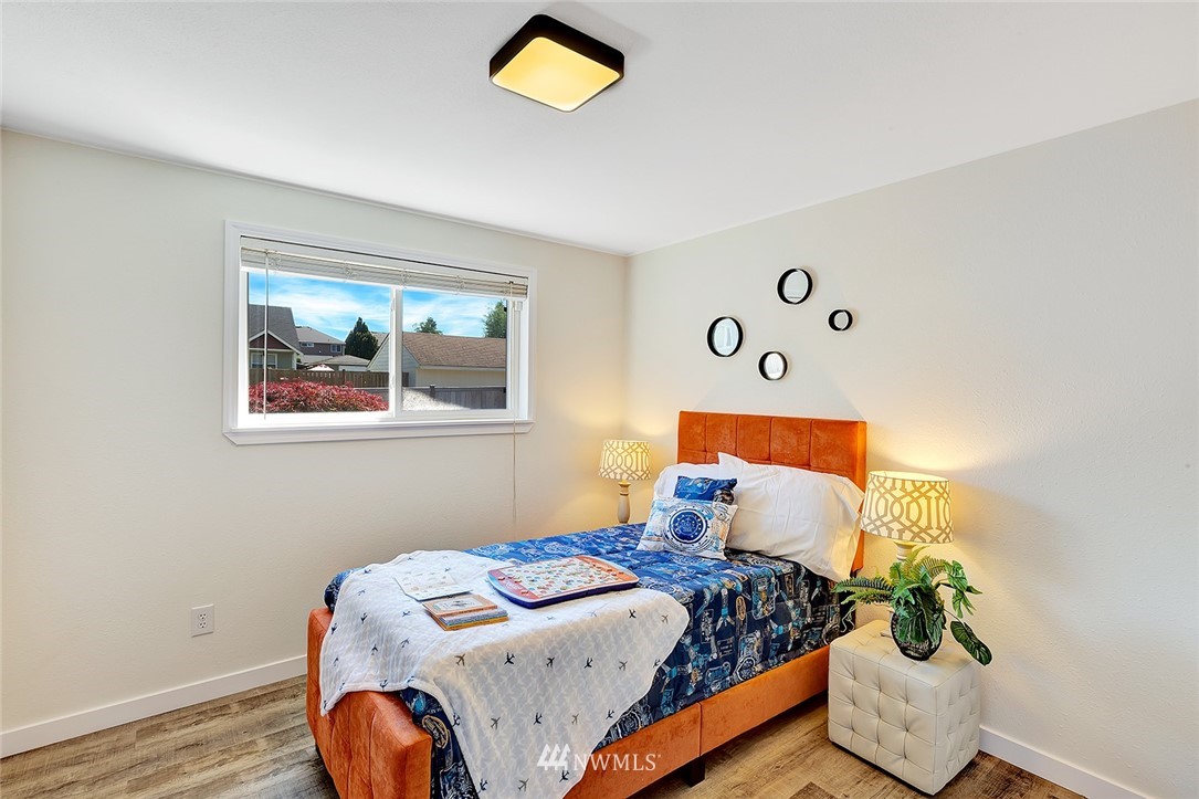 2212 Edmonds Avenue Northeast Renton, WA 98056 - Photo 13 of 18 a bedroom with bed and wooden floor