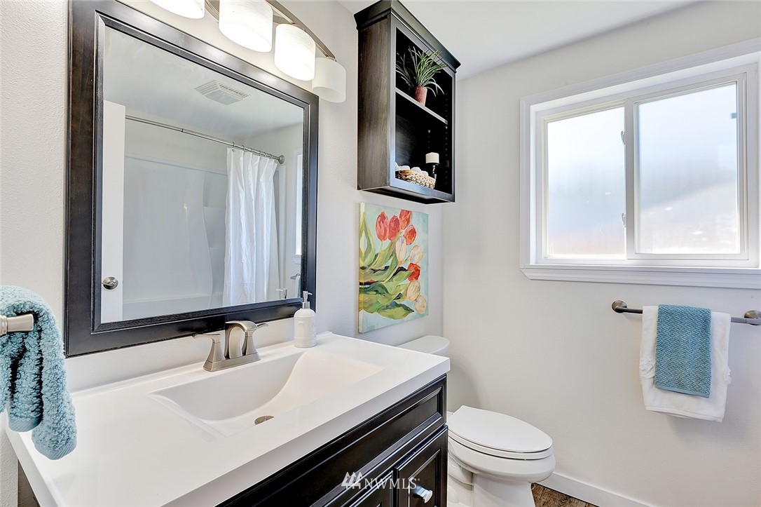 2212 Edmonds Avenue Northeast Renton, WA 98056 - Photo 15 of 18 a bathroom with a sink vanity mirror and toilet