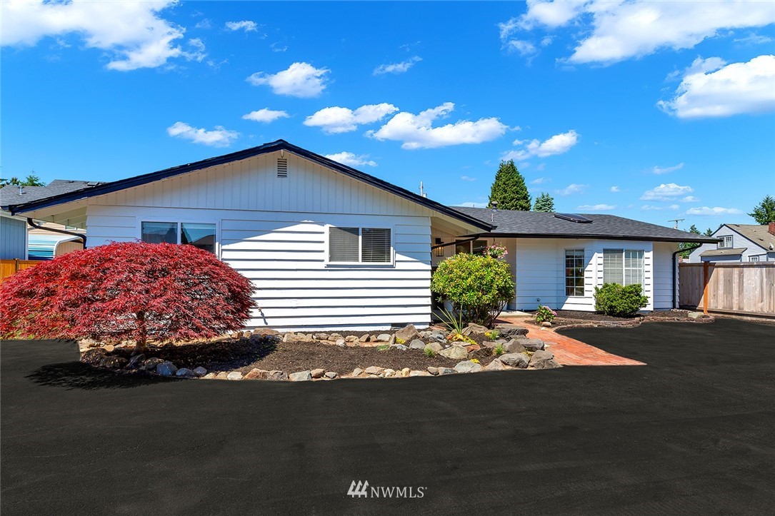2212 Edmonds Avenue Northeast Renton, WA 98056 - Photo 3 of 18 a front view of a house with garden