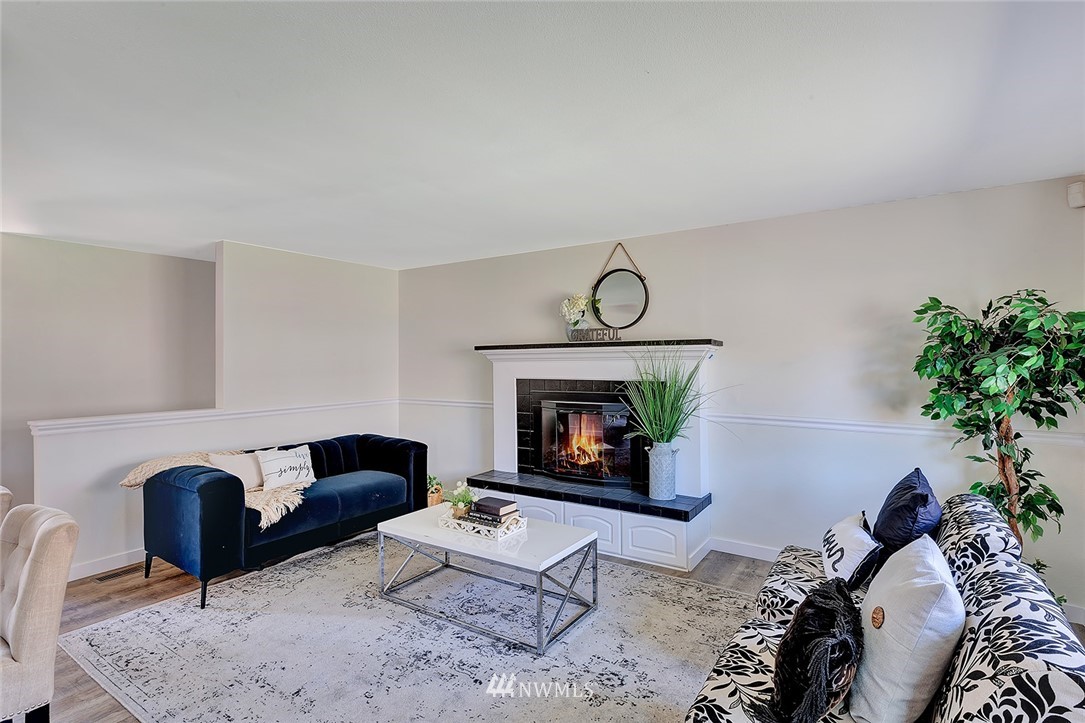 2212 Edmonds Avenue Northeast Renton, WA 98056 - Photo 6 of 18 a living room with furniture and a fireplace