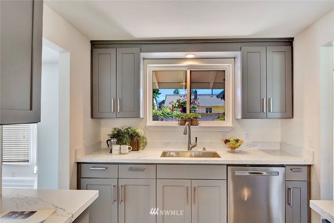 2212 Edmonds Avenue Northeast Renton, WA 98056 - Photo 9 of 18 a kitchen with a sink and cabinets