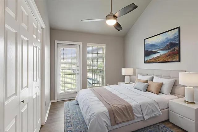 a bedroom with a large bed and a painting on the wall