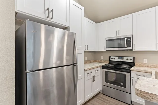 a kitchen with a refrigerator stove and microwave
