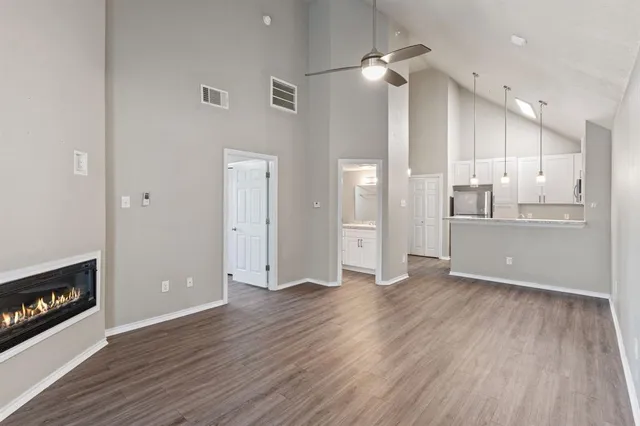 a view of a kitchen with wooden floor and a kitchen