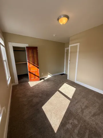 wooden floor with windows and a bathroom