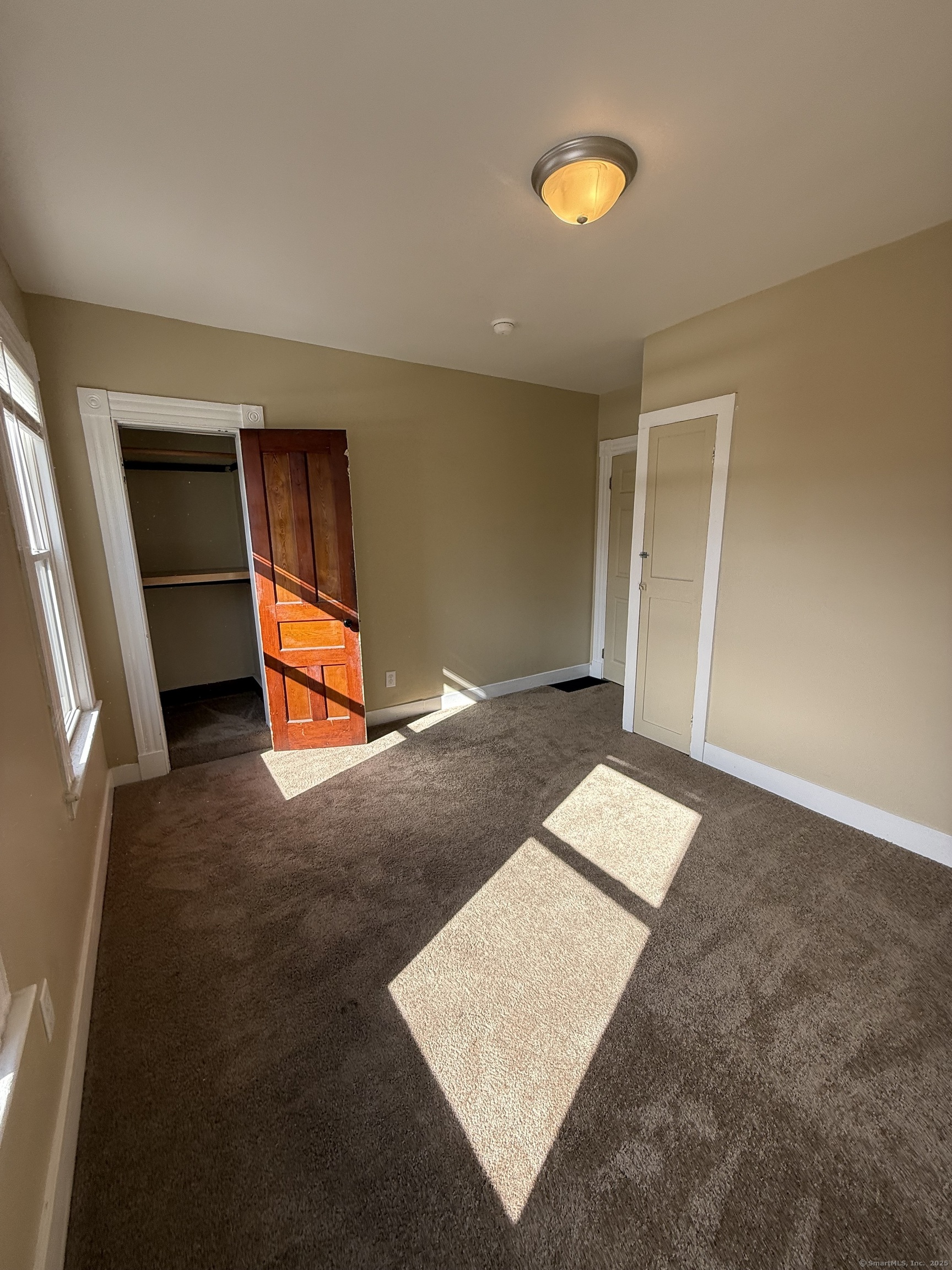 128 Spring Street West Haven, CT 06516 - Photo 12 of 23 wooden floor with windows and a bathroom