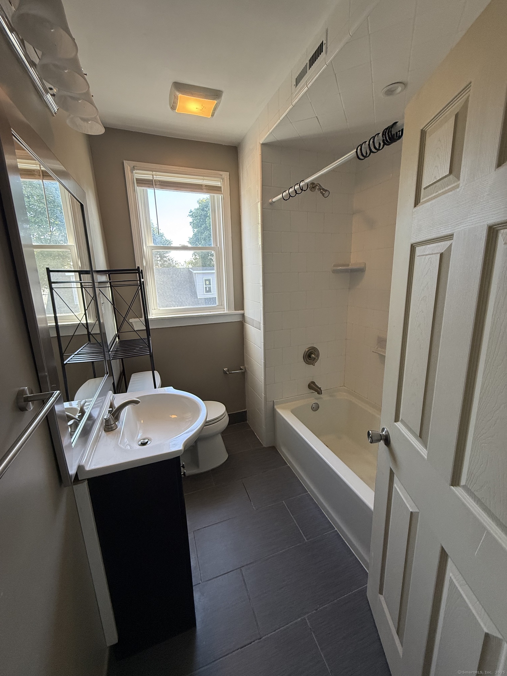 128 Spring Street West Haven, CT 06516 - Photo 7 of 23 a bathroom with a sink a mirror toilet and bathtub