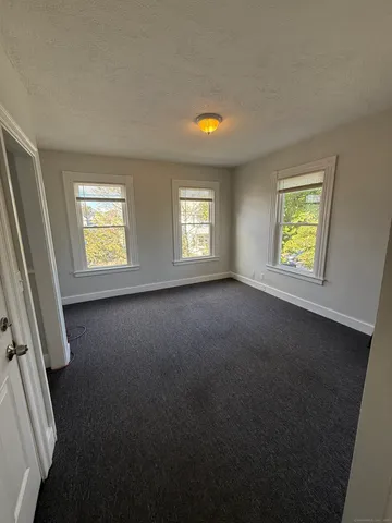 a view of room with window and a fireplace