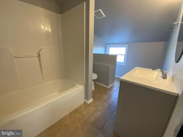 a bathroom with a bathtub sink and toilet