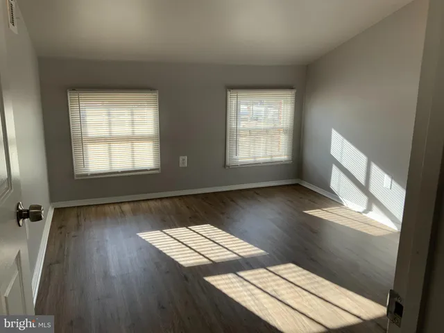 a view of wooden floor and windows in a room