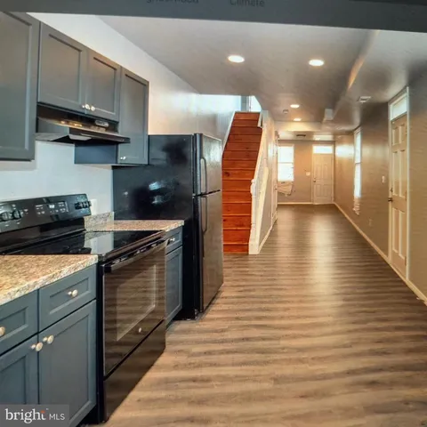 a kitchen with stainless steel appliances granite countertop a stove and a refrigerator