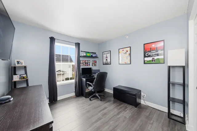 a view of a workspace with furniture and a bedroom