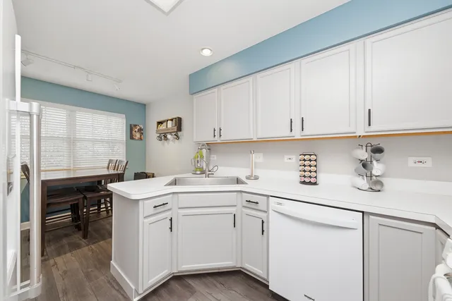 a utility room with cabinets washer and dryer