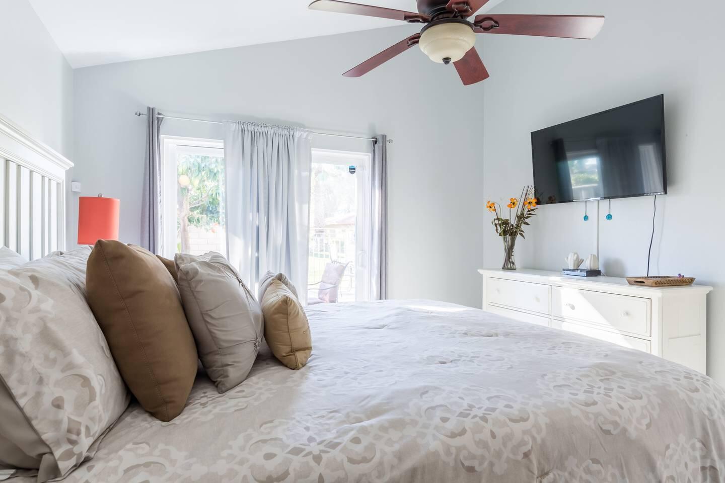 82191 Waring Way Indio, CA 92201 - Photo 17 of 42 a living room with a bed furniture flat screen tv and a window