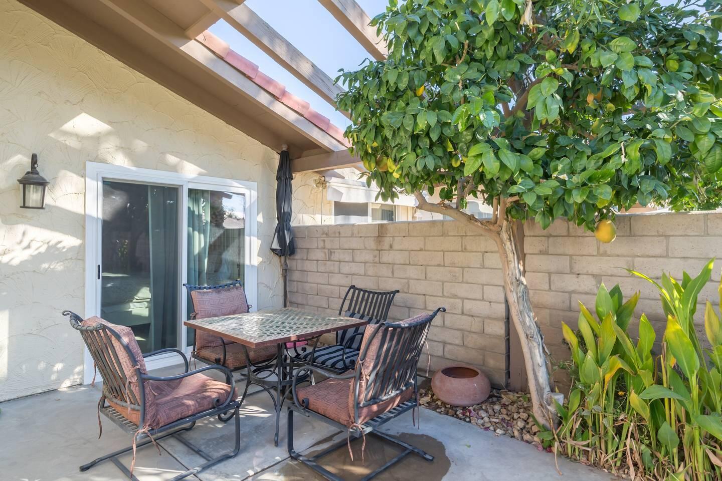 82191 Waring Way Indio, CA 92201 - Photo 31 of 42 a view of a patio with table and chairs and potted plants