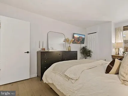 a bedroom with a bed and a dresser