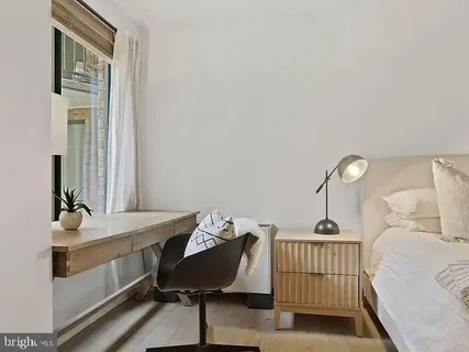 a bedroom with furniture and a window