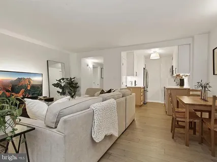 a living room with furniture a dining table and chairs