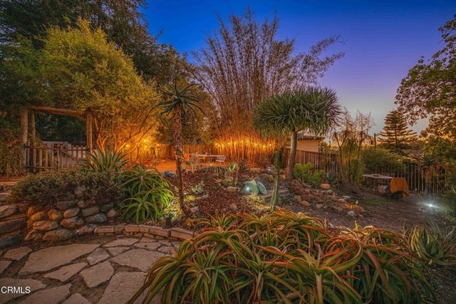 a view of a house with a tree