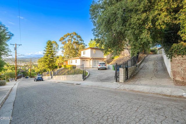an aerial view of a house with a yard