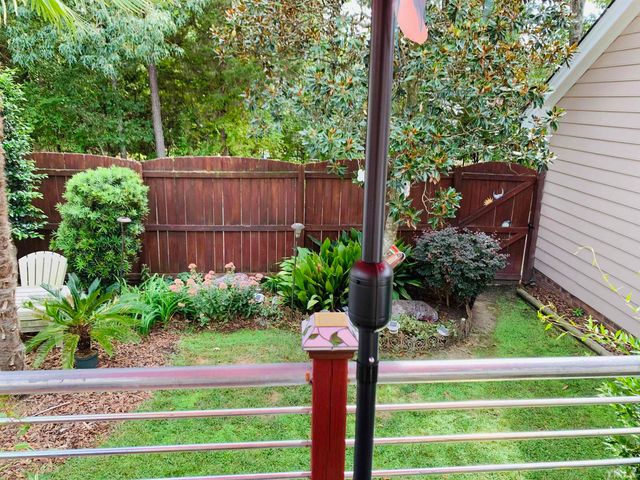 a front view of a house with a yard and potted plants