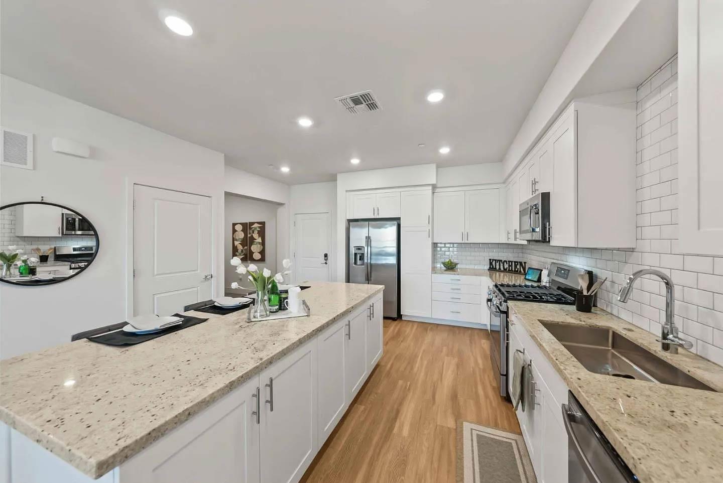 5925 Charlotte Drive, Unit 414 San Jose, CA 95123 - Photo 3 of 18 a kitchen with a sink stove and wooden cabinets